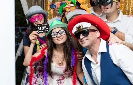 A group of people posing for a photo in a NJ wedding photo booth.