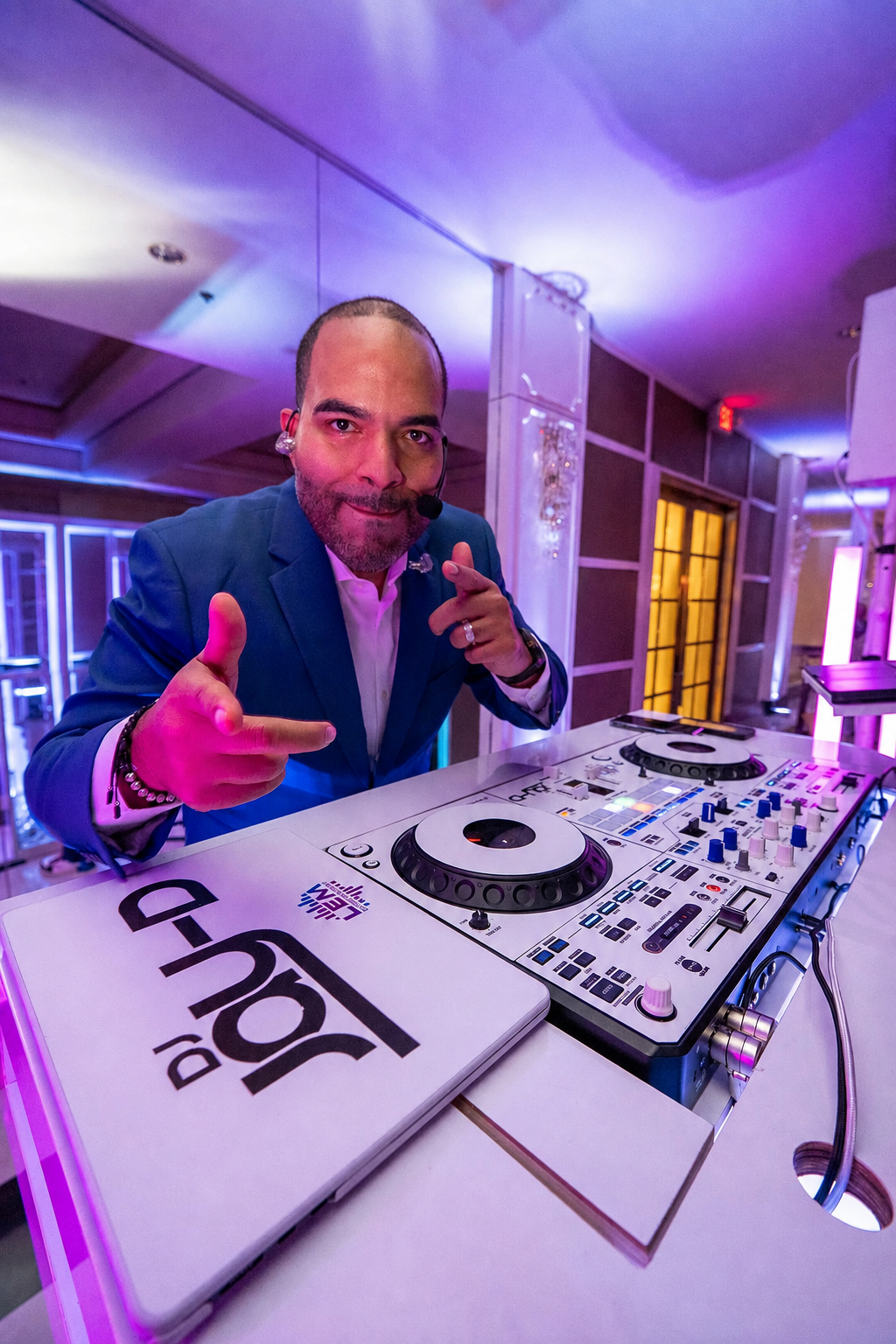 Jose, LEM Entertainment DJ and MC, behind the DJ booth at a wedding.